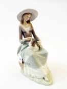 Lladro figure of a lady seated with a dog, 33cm high