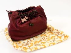 A Radley maroon leather handbag, with bead decoration, and dust bag (af - stain to front)