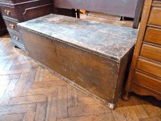 An old pine blanket box, with candle box and iron strap hinges, on a plinth base, width 111cm