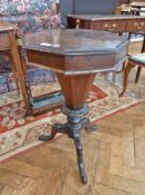 Victorian walnut sewing table, octagonal and tapering on carved tripod cabriole supports
