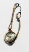 A lady's 9ct gold cased wristwatch with engraved silver dial, gold-plated strap