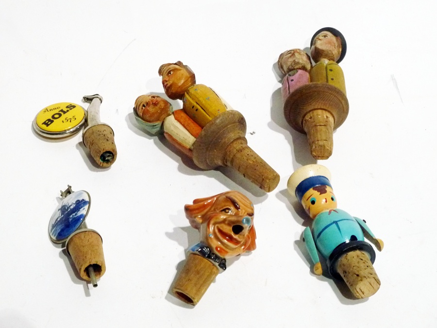 A quantity of novelty stoppers to include:- selection of wooden
figures, one with nodding head, "