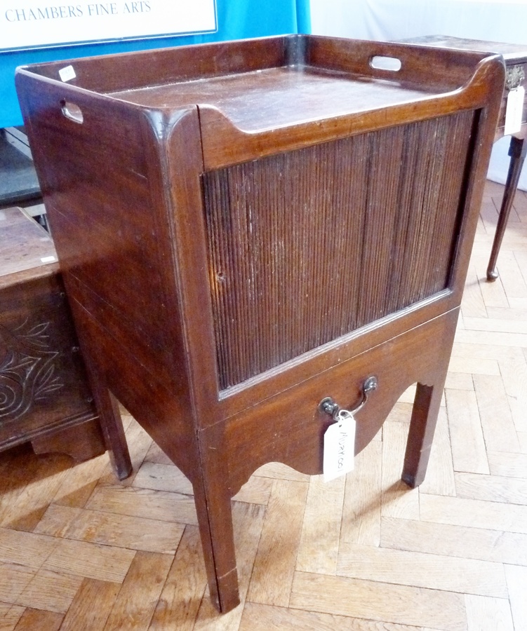 A Georgian mahogany tray-top commode with sliding tambour front, with pot drawer below, on square
