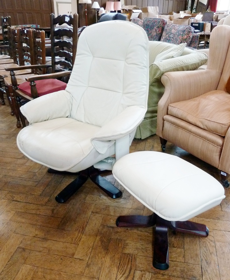 Modern cream leather recliner armchair on splayed quadruple base and the matching footstool