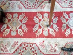 Turkish wool runner, the red ground with floral lozenge medallions, floral borders, 398 x 85cm