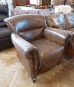 Late Victorian/Edwardian style brass studded leather club armchair, with raised scroll back on