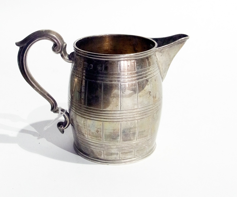 A William IV silver cream jug of reeded barrel form, with scroll handle, Sheffield 1833 by Henry