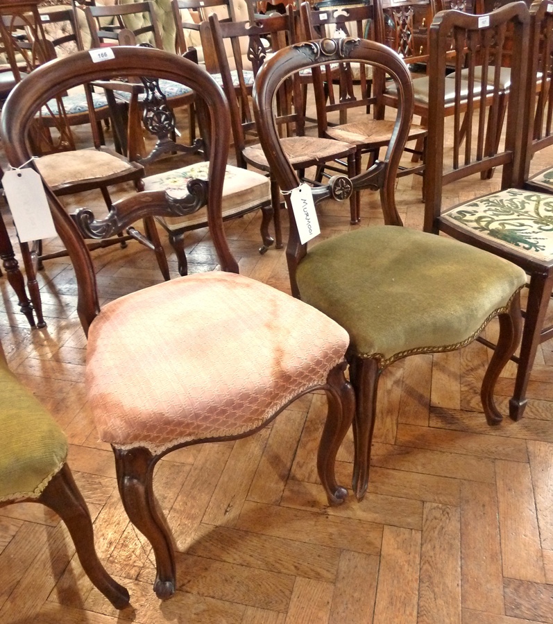 Two Victorian balloon-back dining chairs on cabriole supports