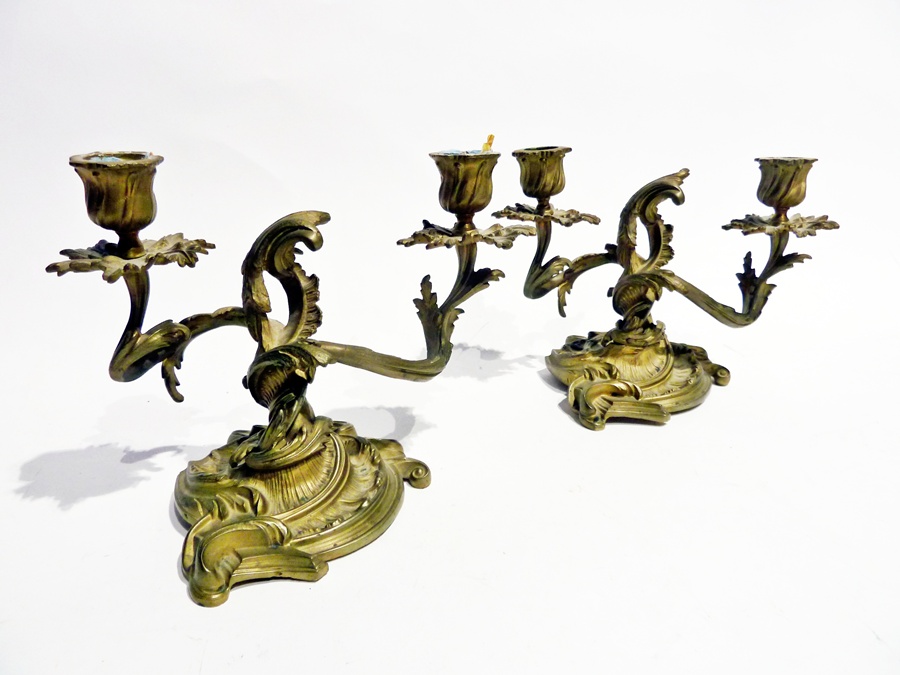 A pair of brass cast candleabra, each two light, foliate decorated, with circular foliate base (2)