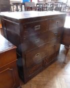 An old oak chest of two short and two long drawers with cupboard below, with flush brass handles,