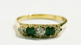 A bright cut sapphire and emerald gold ring, with claw setting