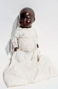 Sprayed black baby doll, with fixed blue eyes, marked foreign, No 4, Pomsons (?), with composition