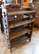 Stained wood four-tier open bookcase, having trefoil pierced uprights