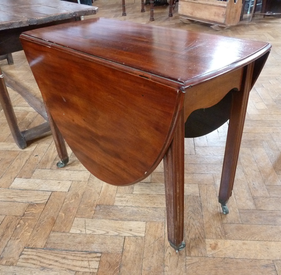 An 18th century mahogany oval-top drop-leaf supper table on square fluted legs with castors, width