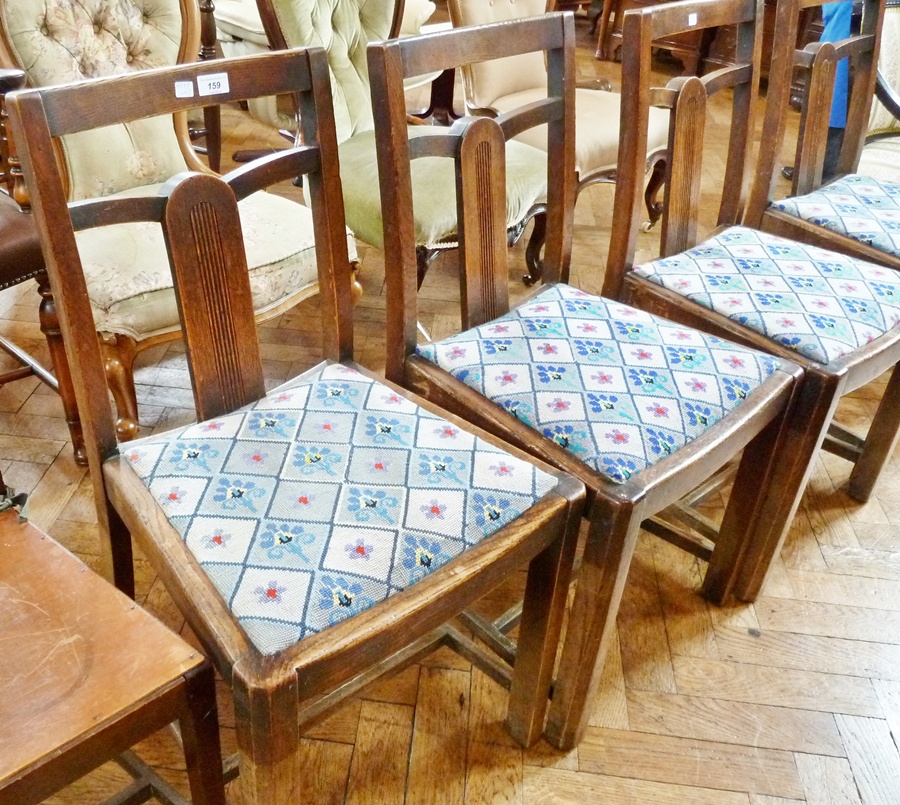 Set of four mid 20th century oak dining chairs with reeded arched central splat, upholstered in