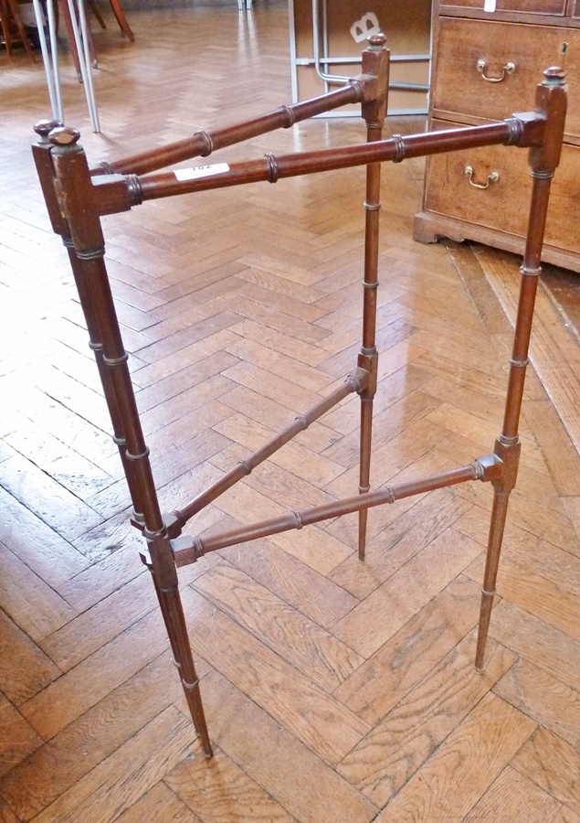 A Georgian ring turned mahogany folding towel rail with elegant proportions and tapering supports,