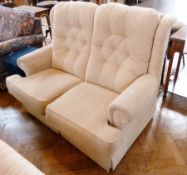 Cream figured dralon two-seater settee with buttonback