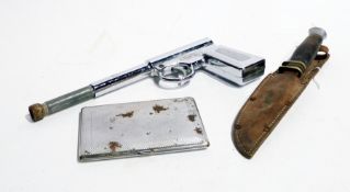 An old sheath knife with leather scabbard, a spring gun, toy revolver, chrome cigarette case, a