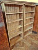 A pair of pine open bookcases, with straight moulded cornice, five shelves and raised on a plinth