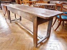 An 18th century French country refectory table, with plain frieze, on square legs united by