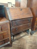 20th century oak bureau, with fitted interior, two long drawers, on turned bulbous supports,