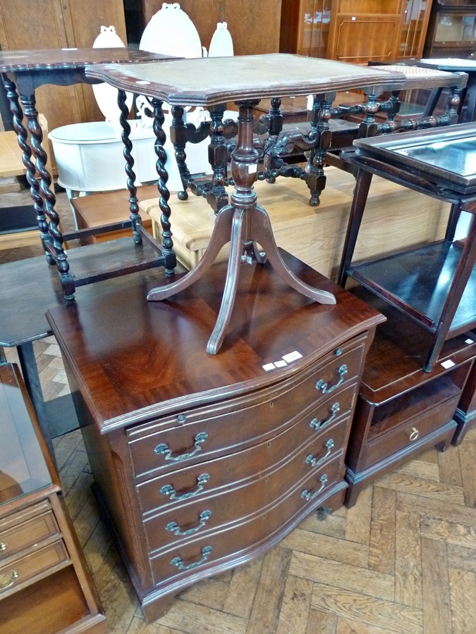 A reproduction mahogany serpentine-fronted bachelor's chest, with brushing slide, four long