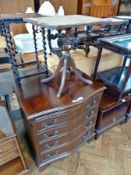 A reproduction mahogany serpentine-fronted bachelor's chest, with brushing slide, four long