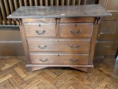 Oak chest with overhanging top, of two short and two long drawers, embossed metal handles, 107cm