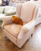 Wing armchair upholstered in pale pink and cream stripe, on square tapering supports and castors