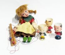 A Pelhams puppet "Dorothy" together with three novelty painted wooden eggcups