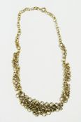 A modern silver/gold overlay circle-pattern graduated collarette necklace