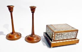 A pair of wood turned candlesticks, another pair, a wooden model of a dog, a sewing box with