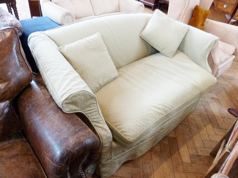 Early 20th century two-seater settee with low back and scroll arms, upholstered in pale-green