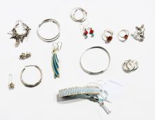 A quantity of costume jewellery to include:- white metal bracelets, hoop earrings, etc.