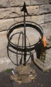 A metal armillary sphere, on stone mount