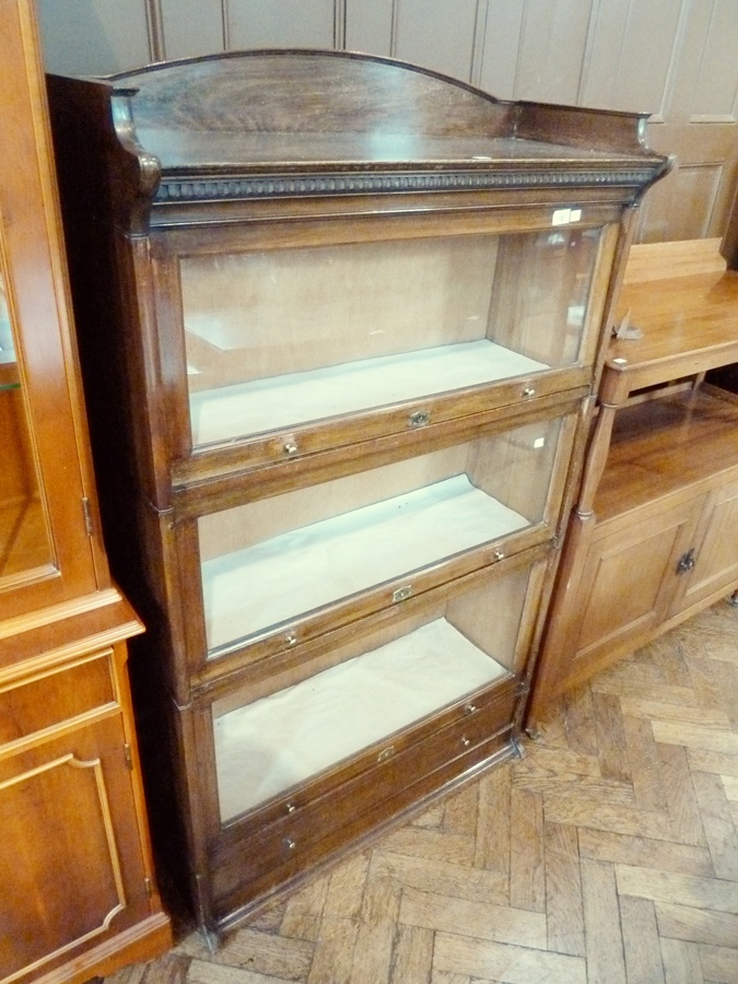 A Globe Wernicke style sectional bookcase, the top with open shelf, with three glazed cupboards
