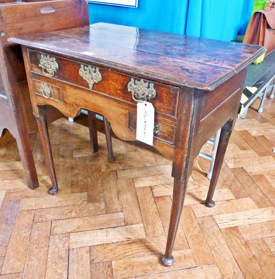 A Georgian oak lowboy with moulded edge top, long frieze drawer with two short drawers either side