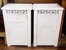 Pair painted bedside cupboards, each with pierced scroll frieze, single drawer, cupboard below