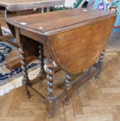 Oak gateleg dining table, oval on spirally turned supports, opening to approximately 122cm long