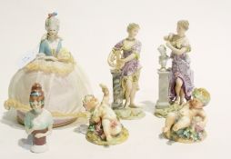 Quantity of continental porcelain figures to include a pair of putti lying on grassy bases, a pair