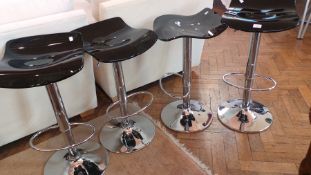 Set of four black perspex and chrome height-adjustable revolving bar stools