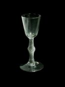 Old English wine glass with trumpet bowl, double air-twist stem with central swelled knop, on a