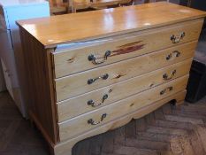 Stained pine chest of four long drawers with brass drop handles and bracket feet