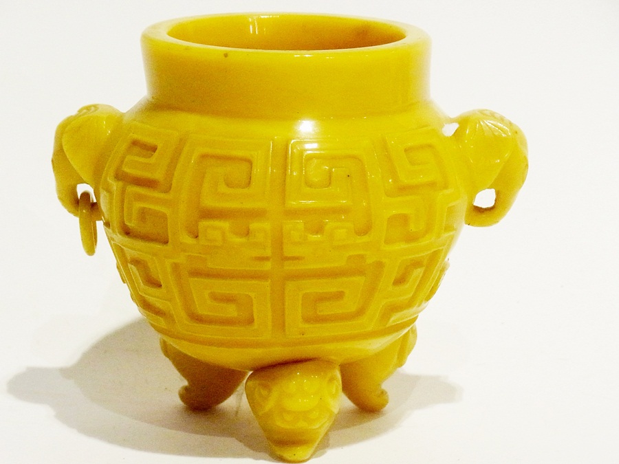 Chinese yellow glass vase of oblate form with character marks to rim, the body with key design and