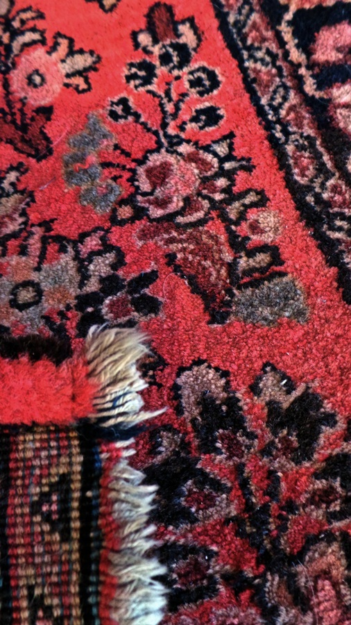 Persian style wool rug, the brick red ground allover floral decorated, 61cm x 120cm approx.