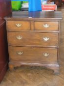 Antique stained fruitwood chest of two short and three long graduated drawers, having brass drop