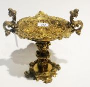 Brass embossed pedestal comport in the rococco style, 18cm high together with an oriental engraved