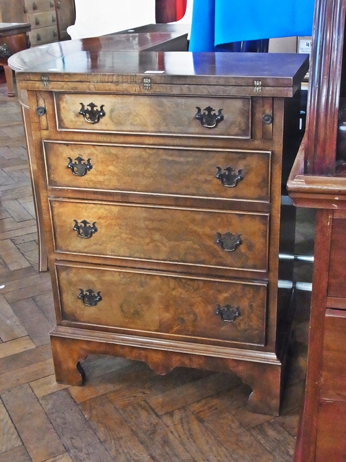 Reproduction figured walnut bachelor's style chest with foldover top, four long graduated drawers,