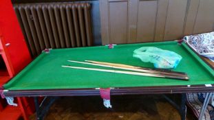 Stained wood folding snooker table with four cues and an assortment of balls