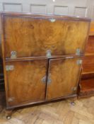 Polished wood cocktail cabinet with pierced brass strap hinges, on stump cabriole supports